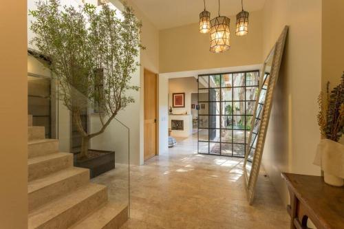 a hallway of a home with stairs and a glass door at Jacaranda House in San Miguel de Allende