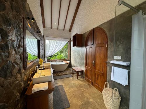 a bathroom with a sink and a bath tub at Tulivu Kilimanjaro Retreat in Moshi