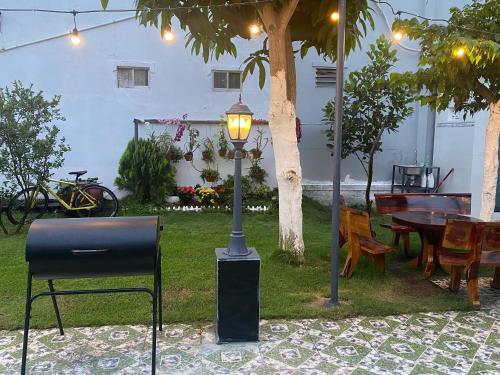 a street light sitting next to a table and chairs at Villa sân vườn Misa in Phan Thiet