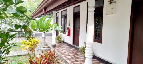 a front door of a house with plants at Dinu Lanka Resort in Katunayake