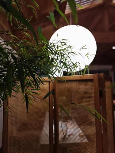 a lamp with a plant on top of a fence at Hantang Inn Hostel Xi'an in Xi'an