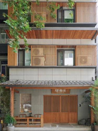 a building with wooden doors and benches in front of it at Hantang Inn Hostel Xi'an in Xi'an