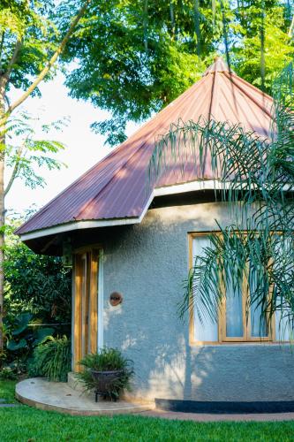 a small house with a rusty roof at Tulivu Kilimanjaro Retreat in Moshi