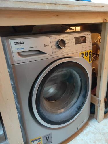 a washing machine under a counter in a room at Youth Palace Hostel هوستل قصر الشباب in Alexandria