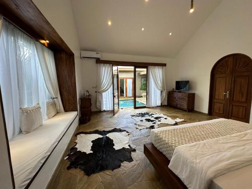 a bedroom with a bed and a tv in it at Tulivu Kilimanjaro Retreat in Moshi
