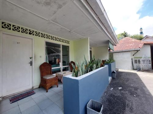 a porch of a house with plants and a door at Grand Syariah Guest House Humanitas in Pematangsiantar