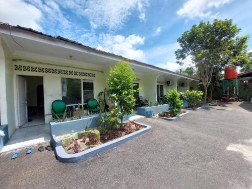 a building with a lot of plants in the courtyard at Grand Syariah Guest House Humanitas in Pematangsiantar