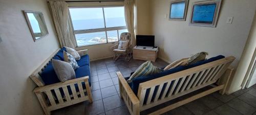 a living room with two couches and a window at 703 High Tide, Holiday Apartment, Main Beach, Amanzimtoti in Amanzimtoti