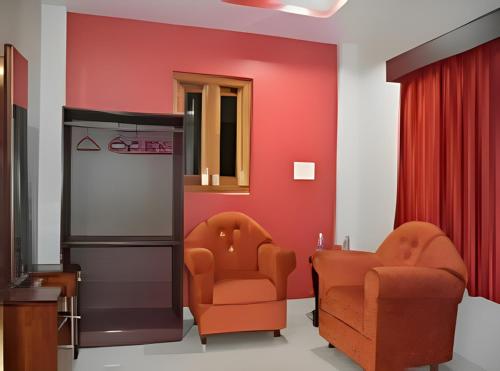 une salle d'attente avec deux chaises et un réfrigérateur dans l'établissement Signature Stay, à Port Blair