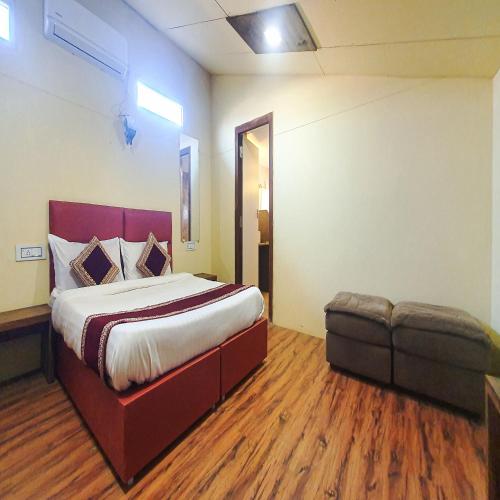 a bedroom with a bed and a bench in a room at Rainforest Resort and Spa, Igatpuri -Nature's Luxury Awaits in Igatpuri