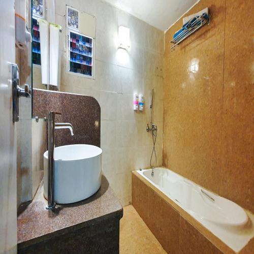 a bathroom with a bath tub and a sink at Rainforest Resort and Spa, Igatpuri -Nature's Luxury Awaits in Igatpuri