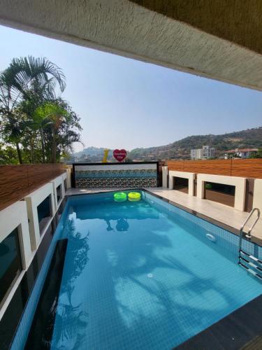 a swimming pool on the roof of a house at THE PERFECT STAYS: CHOUDHARY VILLA in Lonavala