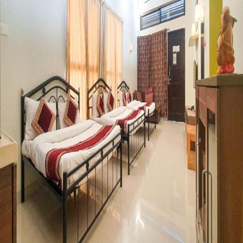 a row of beds in a room at Rainforest Resort and Spa, Igatpuri -Nature's Luxury Awaits in Igatpuri