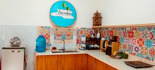 a kitchen with a sink and a surfboard on the wall at Whispering Pines Dalat (Thông Thì Thầm ĐL) in Da Lat