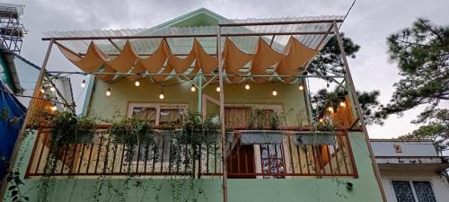a house with a balcony with plants on it at Whispering Pines Dalat (Thông Thì Thầm ĐL) in Da Lat
