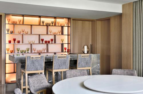 a dining room with a table and chairs at JW Marriott Hotel Bengaluru Prestige Golfshire Resort & Spa in Bengaluru