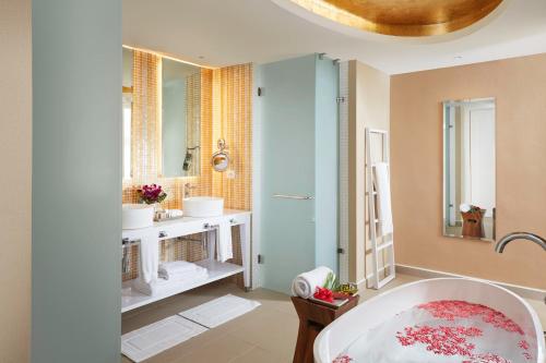 a bathroom with two sinks and a mirror at Azul Beach Resort Negril, Gourmet All Inclusive by Karisma in Negril