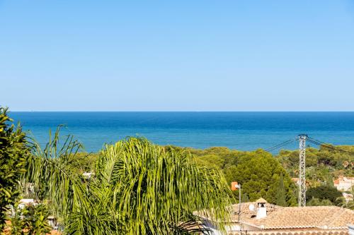 a view of the ocean from a resort at Villa Pura Vida in Denia