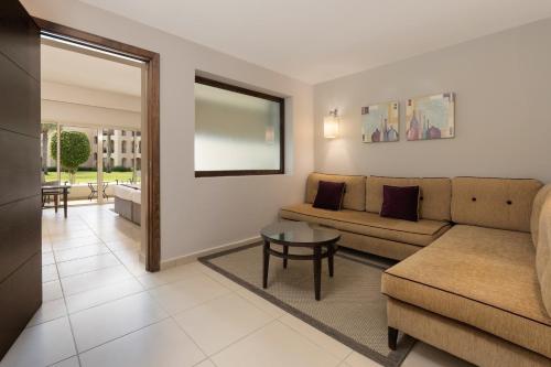 a living room with a couch and a table at JAZ Elite Crystal, Almaza Bay in Marsa Matruh