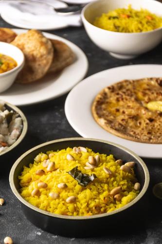a table full of plates of food with rice and beans at DoubleTree by Hilton Gurugram Baani Square in Gurgaon