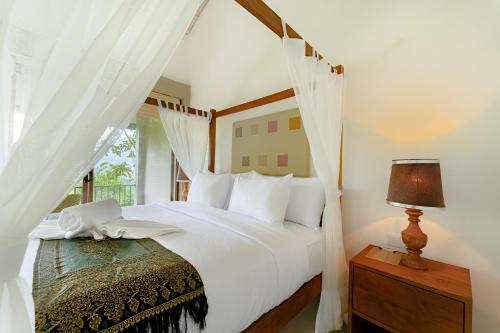 a bedroom with a white bed and a window at Celestial Hills - Villas & Suites by The Clarks in Kandy