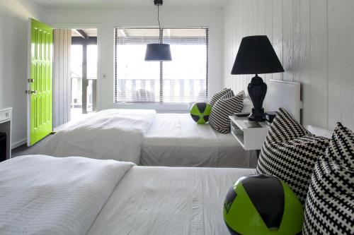 a bedroom with two beds and a large window at Sole East Beach in Montauk