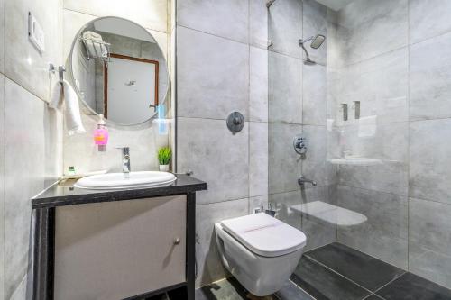 a bathroom with a toilet and a sink and a shower at WESTSIDE HOTEL HiTECH CITY in Hyderabad