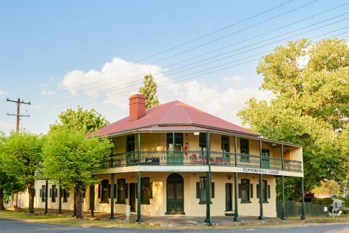 an old building with a balcony on a street at Tenterfield Lodge Caravan Park in Tenterfield