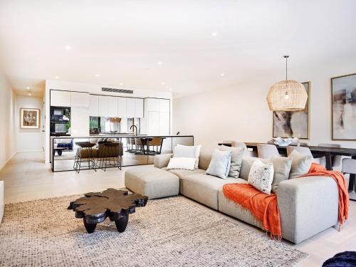 a living room with a couch and a table at Palm Beach Lux Villa in Gold Coast