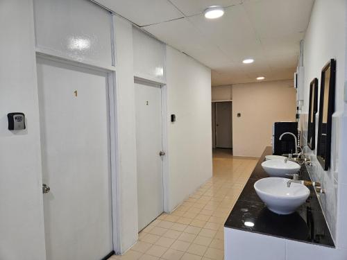 a bathroom with two sinks and two toilets in it at SS HOSTEL PENANG in George Town