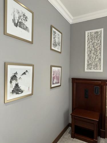 a room with three framed pictures on the wall at Mir Luxe Plaza in Tashkent