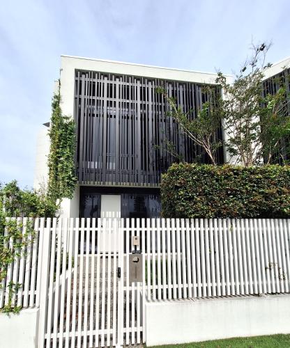 a white fence in front of a white house at Palm Beach Lux Villa in Gold Coast