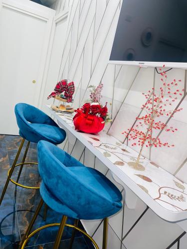 two blue chairs sitting on a counter in a room at Alex mary home in Naples