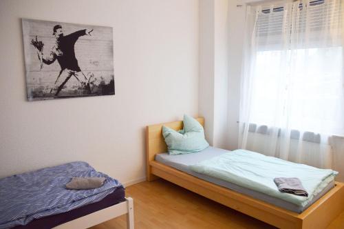 a small bedroom with a bed and a window at Work & Stay in Hagen in Hagen