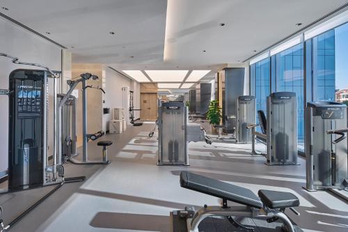 a gym with cardio equipment in a building at Hilton Beijing Tongzhou in Beijing