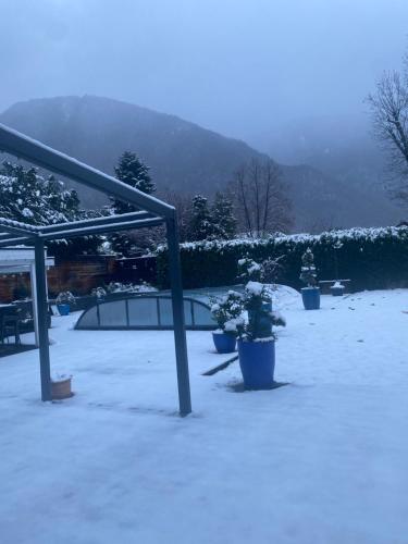 a courtyard covered in snow with potted plants in it at le clos grillet in La Chambre