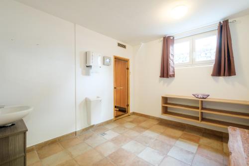 a bathroom with a sink and a toilet and a window at mountain view in Piesendorf