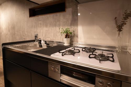 a kitchen with a stove and a sink at Matsubara Container House - Tsuruga, Fukui in Tsuruga