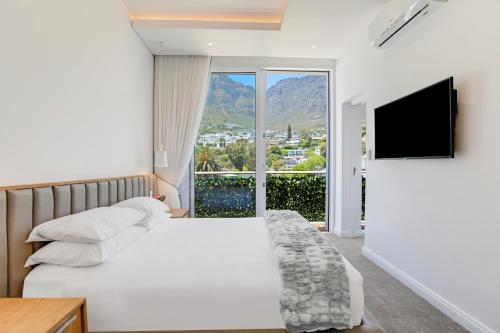 a hotel room with a bed and a large window at The Marly Boutique Hotel in Cape Town
