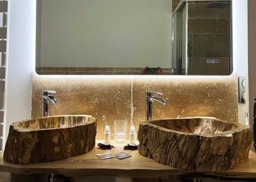 a bathroom with two marble sinks and a mirror at Féerie Love in Puget-sur Argens