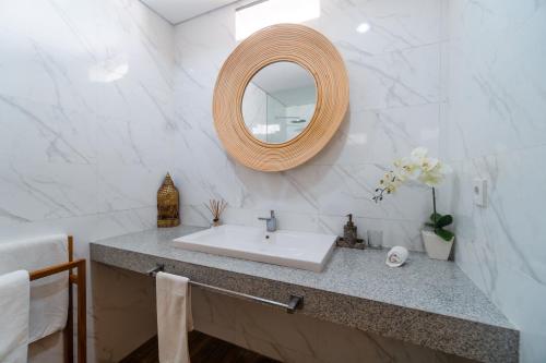 a bathroom with a sink and a mirror at Villa C31 Seminyak in Seminyak