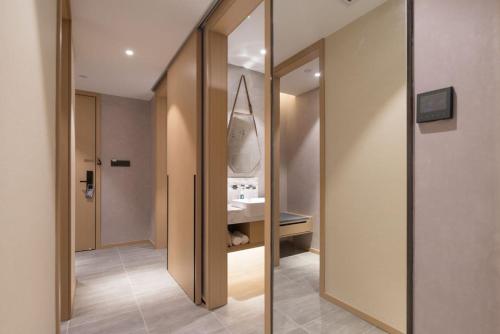 a bathroom with a sink and a mirror at Atour S Hotel Guangzhou Tianhe Taikoo Hui in Guangzhou