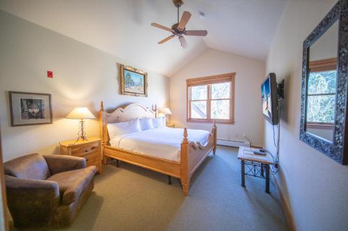a bedroom with a bed and a chair and a fan at Red Hawk Townhomes 2337 in Keystone