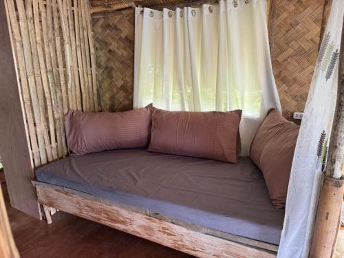 a couch in a yurt with a window at Bice Camp Darocotan in El Nido