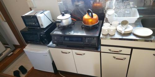 a kitchen with a microwave and a counter top at Yagisawa Corp 103 - Vacation STAY 33494v in Nikko