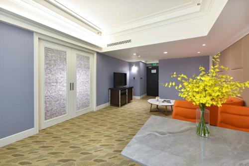 a lobby with a couch and a table and a tv at Fullon Poshtel - Linkou in Guishan