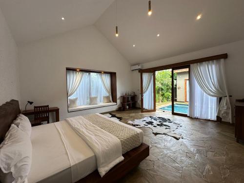 a bedroom with a bed and a large window at Tulivu Kilimanjaro Retreat in Msaranga