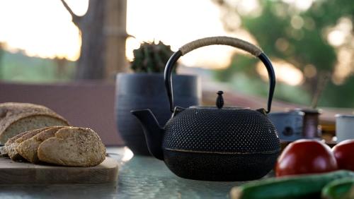 a tea kettle and a loaf of bread on a table at Mountain Retreat in Troodos