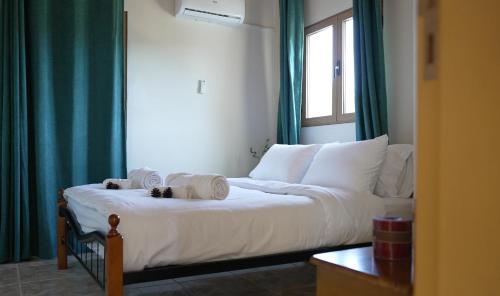 a bedroom with a bed with towels on it at Mountain Retreat in Troodos