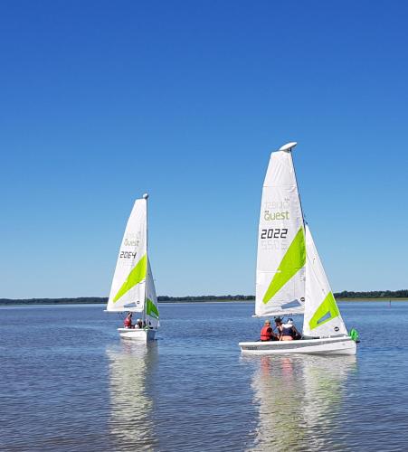 two small sailboats in the water on a lake at Veldemani puhkemaja in Vaibla